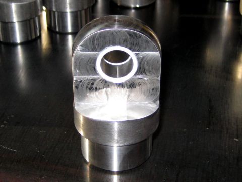 1996 Ford Bronco - A close-up view of a machined metal component, showing its cylindrical base and a U-shaped head with a central bore.