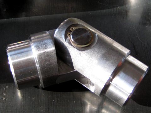 1996 Ford Bronco - A detailed view of a metal universal joint, highlighting its mechanical components and construction.