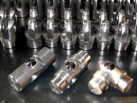 1996 Ford Bronco - Manufactured metal universal joint parts arranged for display or inventory.