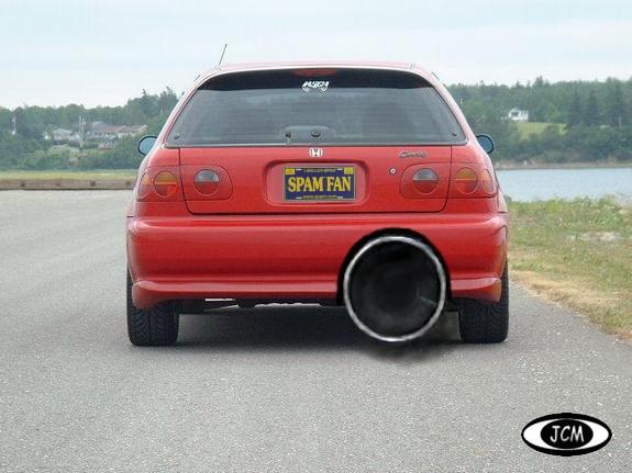 Red hatchback with a huge exhaust pipe and a 'SPAM FAN' license plate