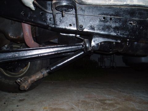 1980 Ford Bronco - Close-up view of the undercarriage of a vehicle, showing mechanical components and frame structure.