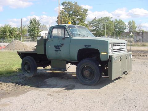 2000 Chevrolet Tahoe - This flatbed truck has a distinctive front grille and body style consistent with models from the late 1970s to early 1980s.