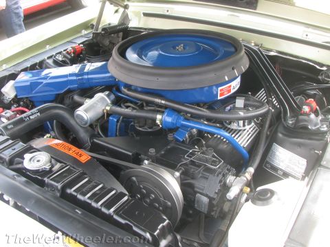 1968 Ford Mustang - Close-up view of the engine compartment of a classic Ford Mustang, highlighting the V8 engine and its components.