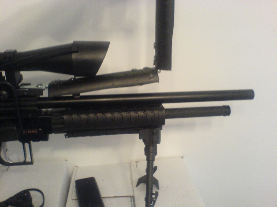 Black rifle scope with bipod attached, mounted on a firearm