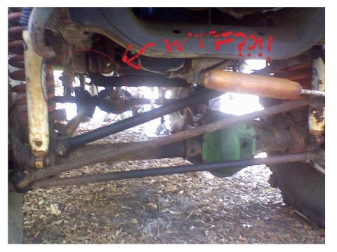 1993 Ford Bronco - Close-up of a vehicle's undercarriage, focusing on suspension and drivetrain components.