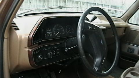 1990 Ford Bronco - Interior view of a 1987 Ford F-150 dashboard with a prominent steering wheel and instrument cluster.