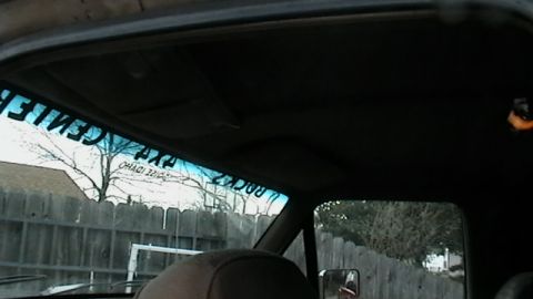 1990 Ford Bronco - Interior view of a vehicle, with a sticker on the windshield visible.