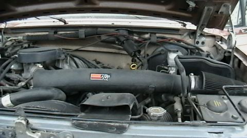 1990 Ford Bronco - The engine bay shows an aftermarket K&N air intake system installed.