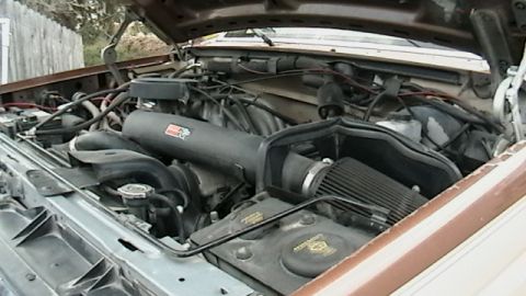 1990 Ford Bronco - The engine bay of a brown 1990 Ford Bronco, showing an aftermarket K&N air intake system.