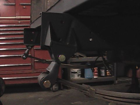 1980 Dodge Magnum - Undercarriage view of a vehicle's suspension system, with a large red toolbox visible to the left.