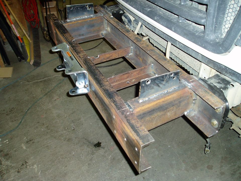 Custom steel bumper assembly with mounting brackets, welded construction, on concrete floor