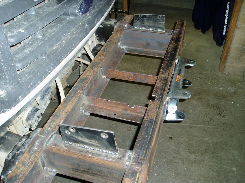 Custom bumper build on a 2000 Ford truck, showing welded steel frame and mounting brackets