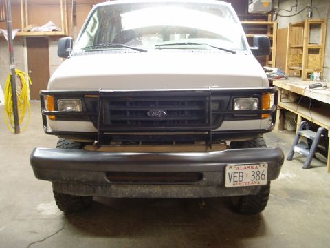 2000 Ford E350 - Front view of a 2000 Ford E350 van equipped with a brush guard and aftermarket bumper.
