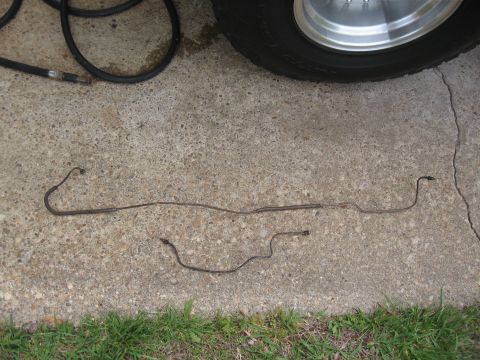 1968 Shelby GT500 - Two original brake lines are laid out on a concrete surface, with a tire visible in the upper right corner.