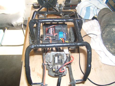 1988 Ford Bronco - The interior of a remote control car chassis reveals its motor, battery pack, and electronic speed controller.