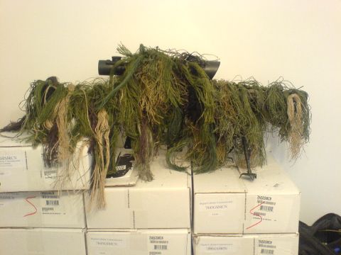 1985 Ford Bronco - A ghillie suit, designed for camouflage, is placed over stacked boxes.
