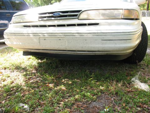 1997 Ford Crown Victoria - Front view of a white 1995 Ford Crown Victoria, showing the grille and bumper.
