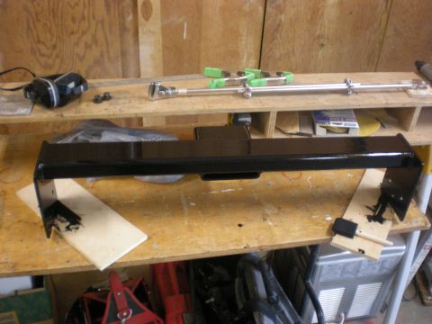 1993 Ford Bronco - A freshly painted trailer hitch receiver sits on a workbench, ready for installation.