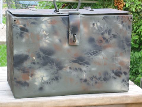 1996 Ford Bronco - This metal toolbox has a camouflage paint job and a latch closure.