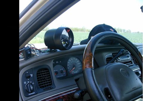 2000 Mercury Grand Marquis - Interior view of a 2000 Mercury Grand Marquis, showing the dashboard, steering wheel, and an aftermarket tachometer.