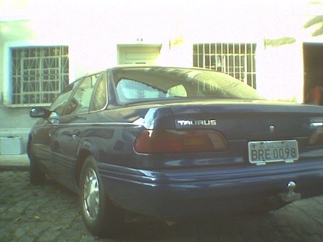 Dark blue 1995 Ford Taurus sedan, rear view, with license plate BRE 0098