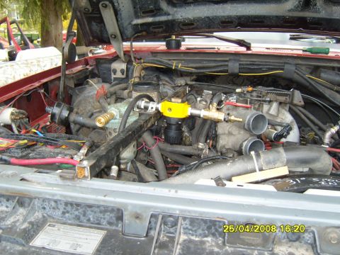 1989 Ford Bronco - Close-up view of a vehicle's engine bay, showing modifications and various engine components.