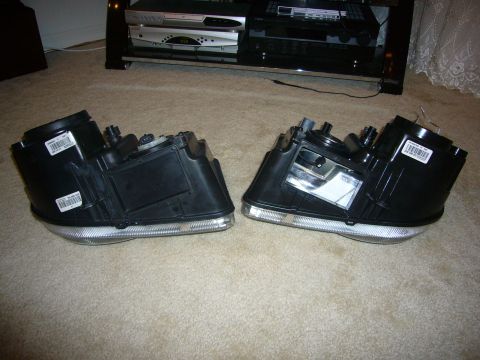 2007 Chrysler 300 - A pair of car headlights are displayed on a carpeted floor in front of an entertainment center.