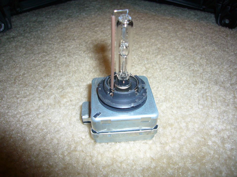 HID headlight bulb and ballast on carpeted surface