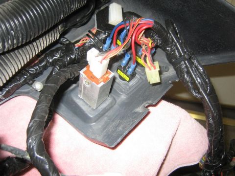 1987 Suzuki Samurai - Close-up view of a vehicle's interior wiring harness and relays, showing various colored wires and connectors.