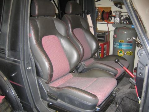 1987 Suzuki Samurai - Car interior shows two seats and background equipment including an air compressor.