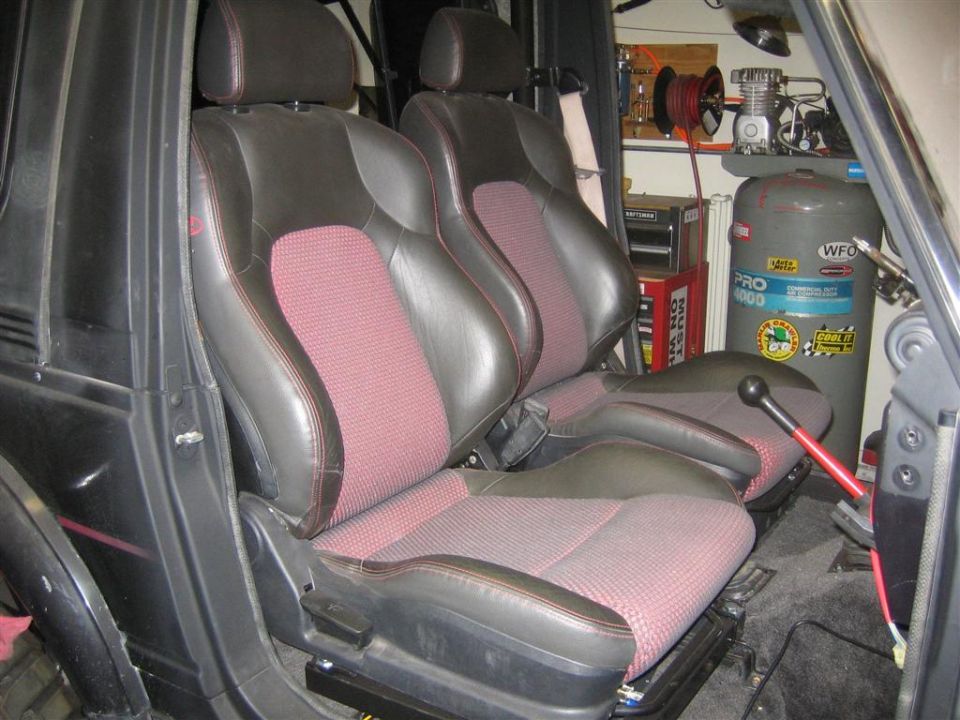 Black and red houndstooth sport bucket seats installed in a small vehicle interior