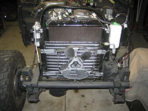 1987 Suzuki Samurai - The front end of a vehicle is shown with its engine and cooling system exposed for work.