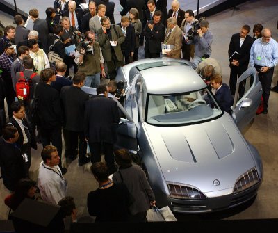 2004 Mercury Messenger - A crowd observes a silver concept car with its doors open at an auto show.