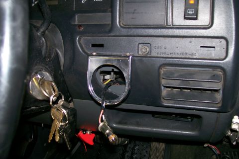 1992 Ford C-350 (Centurion Conversions) - Close-up of a vehicle's dashboard, showing the ignition, a vent, and an empty gauge pod mount.