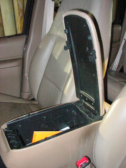 1995 Ford Bronco - Interior shot showing the open center console and tan leather seats.