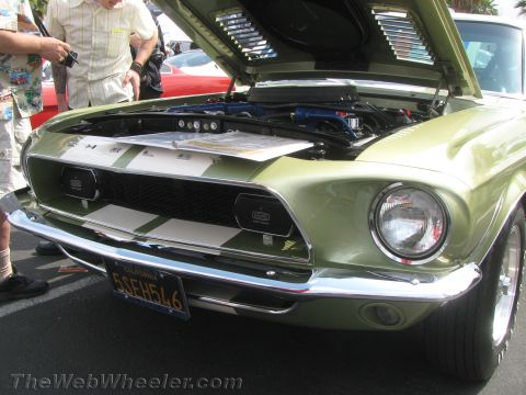 1968 Ford Mustang - This 1968 Ford Mustang is displayed with its hood open, revealing the engine and a prominent front grille with white racing stripes.