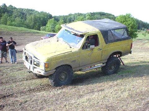 1988 Ford Bronco - Yellow Ford Bronco modified for off-roading gets stuck in the mud during an event.