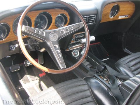 1968 Ford Mustang - The interior of a 1969 Ford Mustang Mach 1 shows off its distinctive woodgrain dashboard and steering wheel.