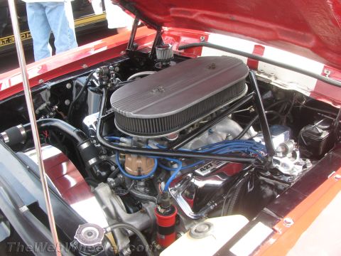 1968 Ford Mustang - The engine bay of a 1968 Ford Mustang reveals a powerful 427 engine with custom chrome accents.