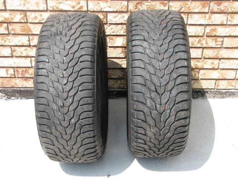 2003 Ford Crown Victoria - A pair of tires are shown against a brick wall. The tread pattern is a V-shape.