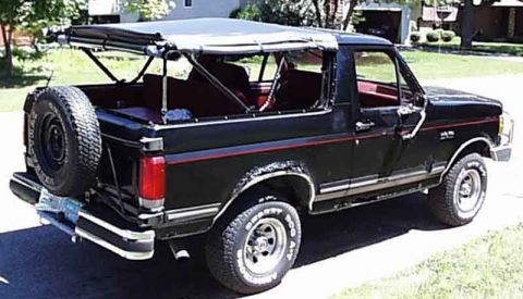 1988 Ford Bronco - This 1988 Ford Bronco has its soft top removed, revealing the interior and the spare tire mounted on the rear.
