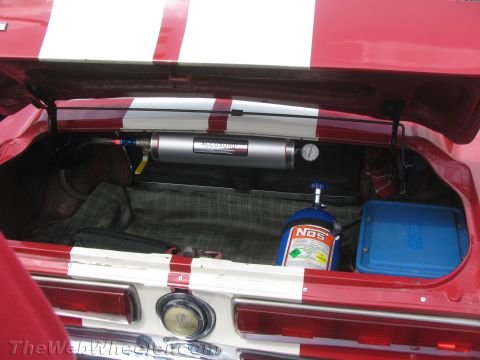 1968 Ford Mustang - The trunk of a 1968 Ford Mustang contains a NOS bottle and an Accusump system, along with racing stripes.