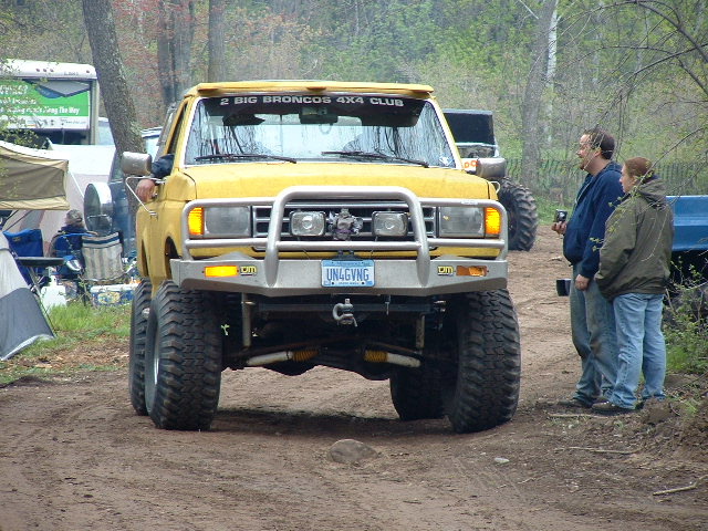 Yellow lifted Ford Bronco with brush guard and winch, 2 Big Broncos 4x4 Club banner