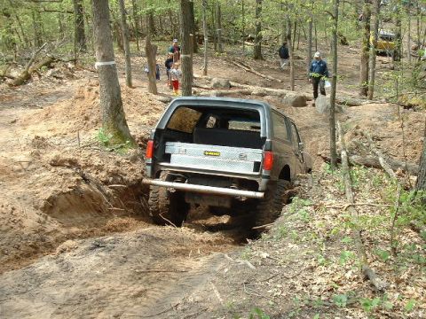 1988 Ford Bronco - This 1988 Ford Bronco navigates a challenging off-road course in a forest setting.