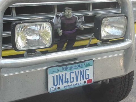 1988 Ford Bronco - A toy figure is mounted on the front of a vehicle, obscuring the grille and headlights.