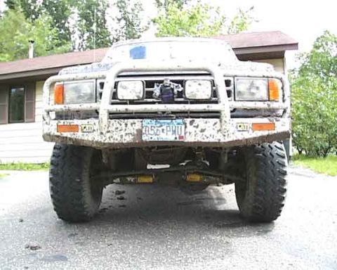1988 Ford Bronco - This SUV is covered in mud, obscuring its exact make and model year.