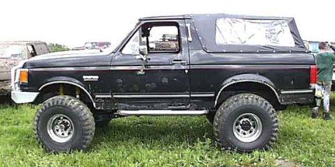 1988 Ford Bronco - This lifted Ford Bronco is ready for off-road adventures with its tires and soft top.