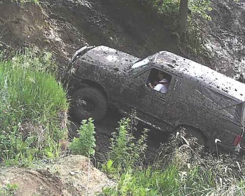 1988 Ford Bronco - This 1988 Ford Bronco navigates a challenging off-road course covered in mud.