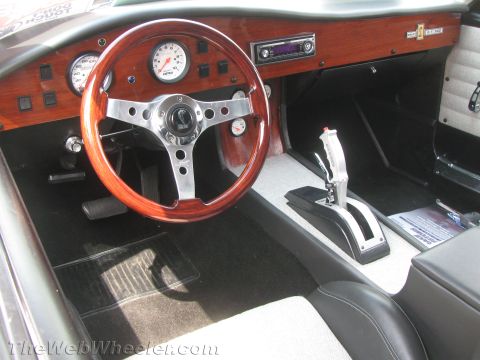 1968 Ford Mustang - Interior view of a 1968 Ford Mustang, a wood-grain dashboard and a custom shifter.