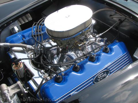 1968 Ford Mustang - Close-up of a Ford V8 engine with blue painted valve covers and chrome accents.